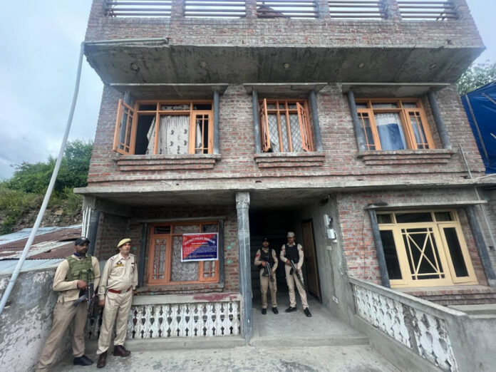 Srinagar Police performing property attachment against drug peddler